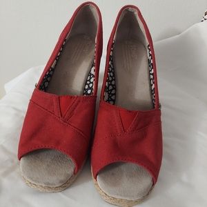 Red TOMS high heels.